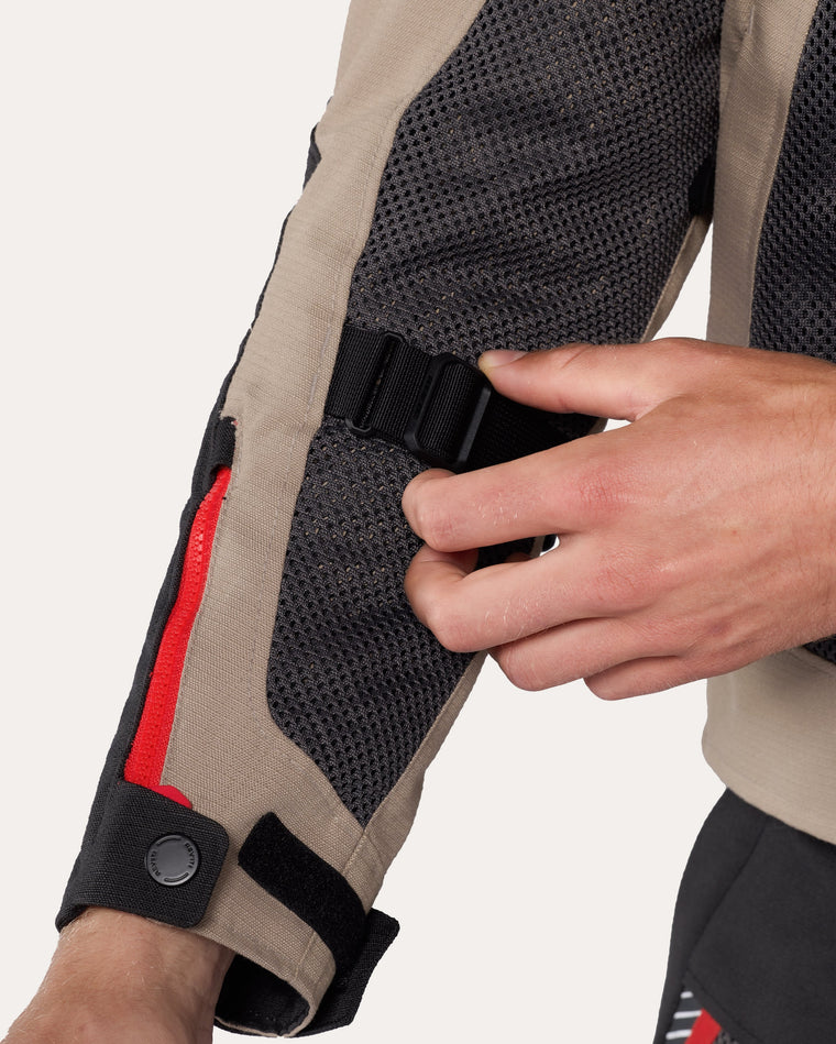 Adjustment strap at lower arm