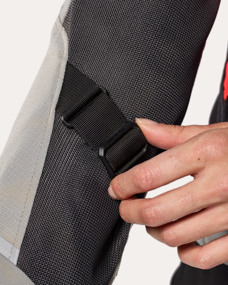 Adjustment strap at lower arm